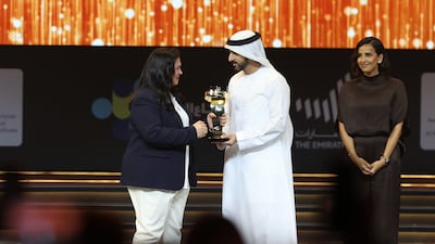 Sheikh Hamdan congratulates Ms Mahmoudi as Ms Al Hajri looks on