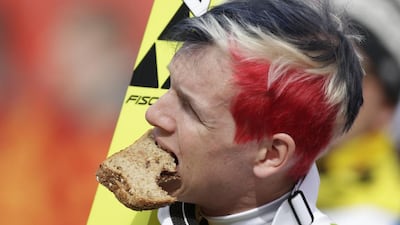 Norway's Magnus Krog takes a break to eat a sandwich during the ski jumping portion of the Nordic combined Gundersen large hill team competition at Krasnaya Polyana, Russia, on February 20, 2014. Matthias Schrader/ AP Photo