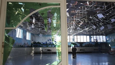 Afghan soldiers inspect a damaged Dubai City wedding hall after an explosion in Kabul, Afghanistan. AP