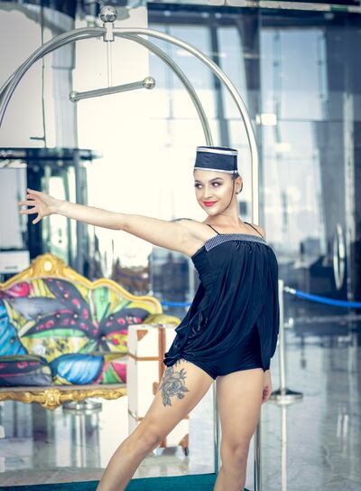 The 'concierge' performs an acrobatic show on the luggage trolley. Photo: Conrad Abu Dhabi