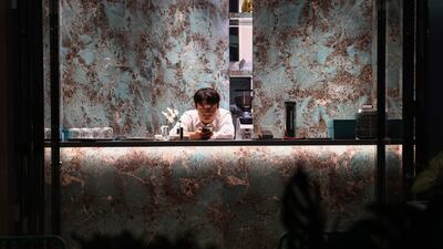An employee uses a device in a bar in Beijing, China. EPA