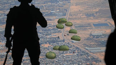 TOPSHOT - This handout picture released by the Jordanian army on April 9, 2024 shows humanitarian aid being airdropped from a military aircraft over the Gaza Strip amid ongoing battles between Israel and the Palestinian militant group Hamas. (Photo by Jordanian army / AFP) / RESTRICTED TO EDITORIAL USE - MANDATORY CREDIT "AFP PHOTO / JORDANIAN ARMY " - NO MARKETING NO ADVERTISING CAMPAIGNS - DISTRIBUTED AS A SERVICE TO CLIENTS