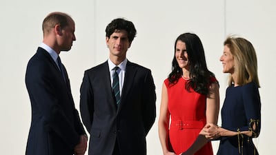 Prince William speaks with Jack and Tatiana Kennedy Schlossberg, the ambassador's children. AFP