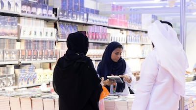 People browse the books at the book fair.