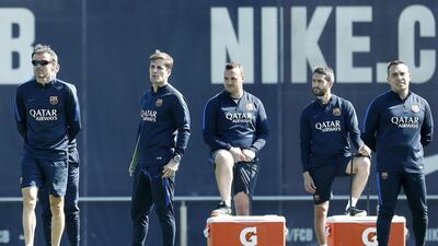 Luis Enrique, far left, and his fellow coaches watch players train. Andreu Dalmau / EPA