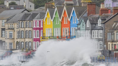 Waves crash on to a road in Whitehead, Northern Ireland. PA
