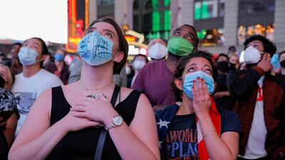 People watch a speech by Democratic vice presidential nominee Kamala Harris, at Times Square in New York City. Reuters