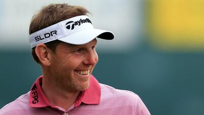 Stephen Gallacher of Scotland acknowledges the crowd on the 18th hole during the third round of the Dubai Desert Classic on Saturday. Gallacher holds a two-stoke lead on Rory McIlroy. AP Photo