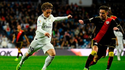 Real Madrid Luka Modric (L) vies with Rayo Vallecano defender Alex Moreno. AFP