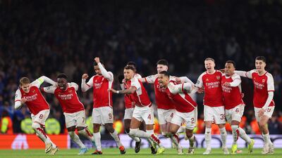 Arsenal players start running in celebration as David Raya makes the match-winning save. Getty Images