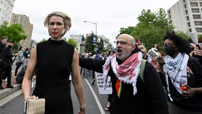 A guest is harangued as she arrives at the White House Correspondents' Association dinner. AP