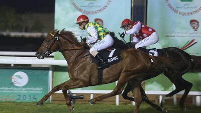 Silvestre De Sousa let his mount Raaziq lead the way even as he lost the iron on his right side, as the pair edged out Skoop, riden by Tadhg O’Shea at the Abu Dhabi meeting. Delores Johnson / The National