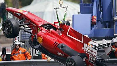 Fernando Alonso's Ferrari is removed from the track at the Monaco Grand Prix after an accident which prevented the Spaniard from taking part in qualifying.