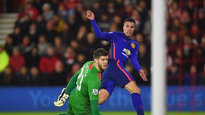 Robin van Persie of Manchester United scores past Fraser Forster of Southampton for the opening goal in United's win on Monday in the Premier League. Michael Regan / Getty Images