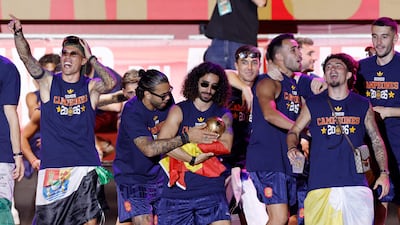 Defender Marc Cucurella, centre, with the World Cup trophy at Cibeles Square. AFP