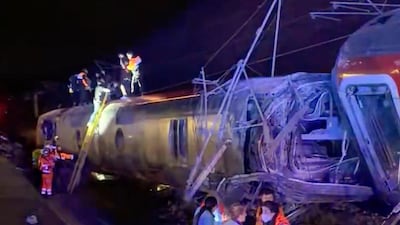Emergency personnel on the scene after a train accident in Adamuz, southern Spain, on Sunday. At least 21 people died. AFP