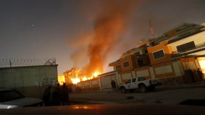 Afghan security forces keep watch while smoke and fire rise from a foreign aid guest house after a Taliban attack in the Afghan capital of Kabul November 29. Omar Sobhani / Reuters