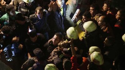 Rescue workers and civilians pull a survivor from the rubble. Ahmed Abdel Fattah / El Shrouk Newspaper / AP Photo