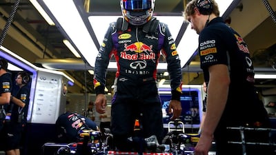 Carlos Sainz Jr of Red Bull gets into his car in the garage. Dan Istitene / Getty Images