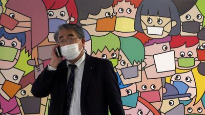 A passerby wearing a protective face mask walks on the street amid the COVID-19 outbreak in Tokyo, Japan. REUTERS / Stringer