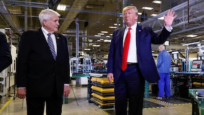 US President Donald Trump speaks next to US Rep John Carter during a tour of Apple's Mac Pro manufacturing plant. Reuters