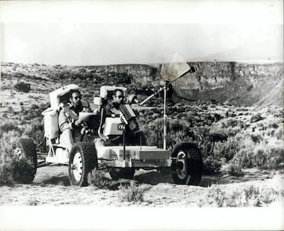 ‘Apollo 15’ crew members James Irwin, left, and David Scott practise driving a lunar vehicle in New Mexico. Alamy Stock