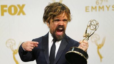 Actor Peter Dinklage poses backstage with his award for Outstanding Supporting Actor in a Drama Series for his role in HBO's Game of Thrones. Reuters