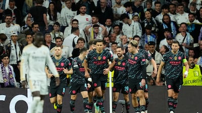 Bernardo Silva, third right, celebrates with his teammates after scoring Manchester City's opening goal in the Champions League quarter-final first leg against Real Madrid at the Santiago Bernabeu stadium in Madrid, Spain, on Tuesday, April 9, 2024. AP