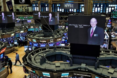 Images honouring the memory of Jack Welch appear on screens above trading posts on the floor of the New York Stock Exchange on Monday, March 2, 2020. Richard Drew / AP