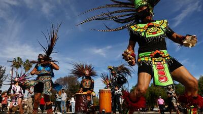 Members of Aguilas del Tepeyac dance following the traditional procession and Mass in honor of Our Lady of Guadalupe at San Gabriel Mission amid the pandemic in San Gabriel, California. AFP