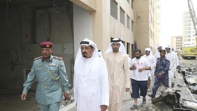 Sheikh Humaid bin Rashid Al Nuaimi, Supreme Council Member and Ruler of Ajman, tours the site of the blaze. WAM