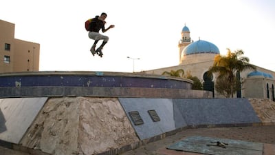 Palestinain Mahmoud Neta,20, jumps over the dry fountain by the Sheikh Zaid Mosque in the Sheikh Zayed City housing project in Gaza. Heidi Levine for The National