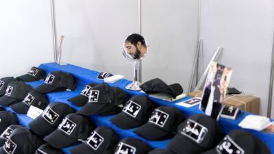 Abdul Fattah Abu Maaroof sells customised hats with names emblazoned across the front. Reem Mohammed / The National