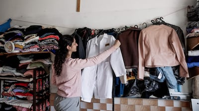 A displaced Palestinian girl hangs up clothing in a shelter inside the Holy Family Catholic Church compound in Gaza City. AFP