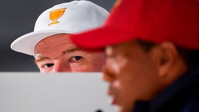 International Team captain Ernie Els of South Africa listens to captain of the US team Tiger Woods. AFP