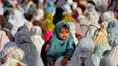 A child looks as Indonesians Muslims attend an Eid Al Adha prayer at the Baiturrahman grand mosque in Banda Aceh. AFP