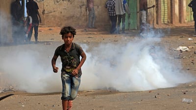A Sudanese boy flees tear gas fired by security forces during a demonstration against military rule in Khartoum on June 30, 2022. AFP