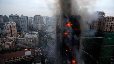 Firefighters try to extinguish the blaze at the building in Shanghai.