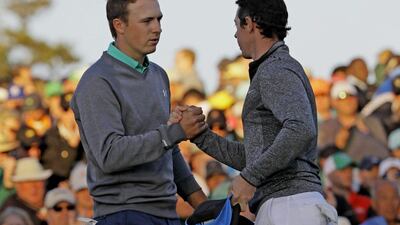 Jordan Spieth, left, shakes hands with Rory McIlroy, of Northern Ireland, on the 18th green during the third round of the Masters golf tournament Saturday, April 9, 2016, in Augusta, Ga. (AP Photo/David J. Phillip)