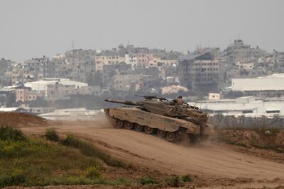 An Israeli tank moves near the border with the Gaza Strip as seen from a position on the Israeli side of the border on March 17, 2024. Getty Images.