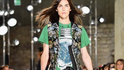A Louis Vuitton timepiece is printed on a green T-shirt and paired with a long, brocade vest. Pascal Le Segretain / Getty Images