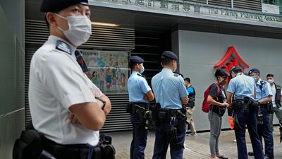 A protester is searched by police officers during a demonstration against an Election Committee voting in Hong Kong on Sunday. Photo: AP