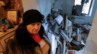 Lyudmila surveys her damaged home after recent shelling in Donetsk, Ukraine. Reuters