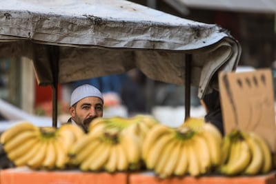 A street vendor waits for customers in the Druze-majority city of Jaramana on Sunday. AFP