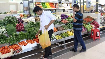Shoppers in the fruit section of Souq Al Jubeil in Sharjah. The new home for the market, developed at a cost of Dh195m, has met with a warm welcome from shoppers and traders and will officially open for business on Friday. Pawan Singh / The National