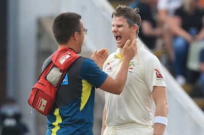 Steve Smith is checked over by medical staff after being struck by the ball. Lindsey Parnaby / AFP
