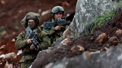 Israeli soldiers stand guard at the site of their excavation work. AP Photo