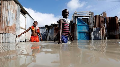 Somali children wade through flood waters after heavy rain in Mogadishu, Somalia. Reuters