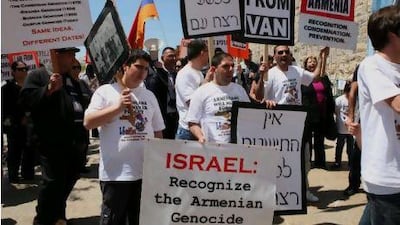 Members of the Jerusalem Armenian community hold placards as they march during commemorations for the 96th anniversary of mass killings of their ancestors under the Ottoman Empire, at Jaffa Gate in Jerusalem's Old City. Gali Tibbon / AFP Photo