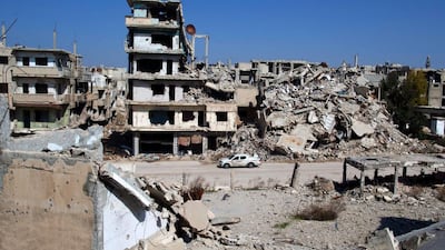 A car drives through a devastated part of the old city of Homs, Syria. Major players in Syria’s war traded accusations over violations of the first major ceasefire in the five-year conflict, but the truce remained largely intact. Hassan Ammar / AP